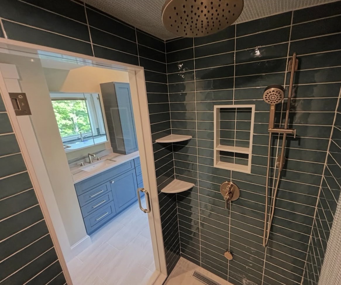 Custom bathroom remodel with green tile shower and rainfall shower head